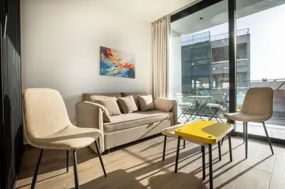 a living room with a couch and two chairs at Irinis 150 Urban Luxury Studios in Limassol