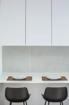 two chairs sitting under a counter with cabinets at Irinis 150 Urban Luxury Studios in Limassol