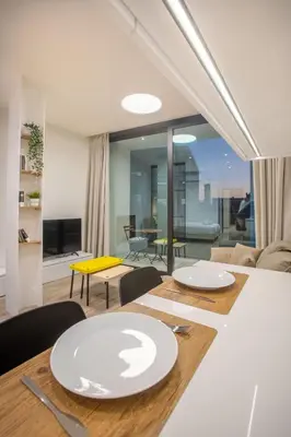 a dining room with a table with white plates on it at Irinis 150 Urban Luxury Studios in Limassol