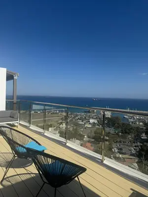 a view of a balcony with a chair and the ocean at Stunning Penthouse with Sea and City View in Larnaka