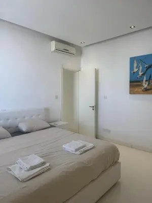 a bedroom with a bed with two towels on it at Stunning Penthouse with Sea and City View in Larnaka