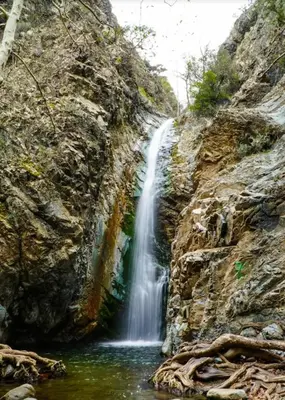 a waterfall in the middle of a rocky canyon at Anastasi Tiny Homes- Mountain Views, Garden & Terrace, Pet Friendly in Kakopetria