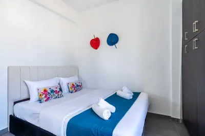 a white bed with two stuffed animals on top of it at Phoenix 2-Bedroom Apartment in Larnaka