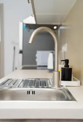 a sink with a faucet in a kitchen at 1 bedroom flat next to university in Aglantzia