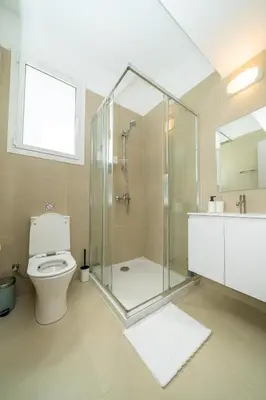a bathroom with a shower and a toilet and a sink at 1 bedroom flat next to university in Aglantzia