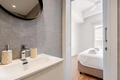 a bathroom with a sink and a mirror at The Central Flat Limassol in Limassol