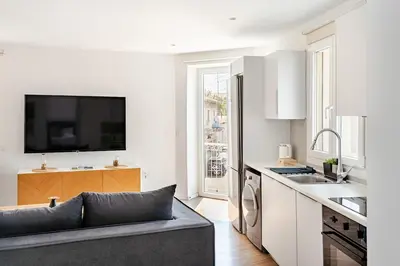 a living room with a couch and a kitchen at The Central Flat Limassol in Limassol