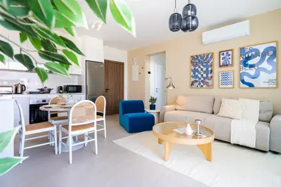 a living room with a couch and a table at Jas Living - Chic Apts & Balconies in Larnaca in Larnaka