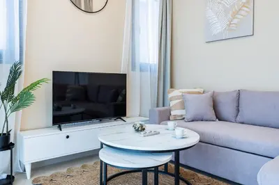 a living room with a couch and a table at Jas Living - Chic Apts & Balconies in Larnaca in Larnaka