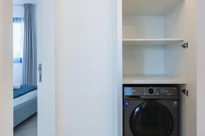 a kitchen with a washing machine in a room at Jas Living - Chic Apts & Balconies in Larnaca in Larnaka