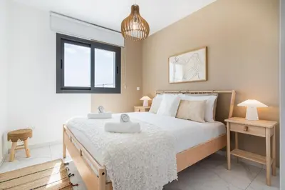a bedroom with a bed with two towels on it at Vervana 2-Bedroom Apartment in Larnaka