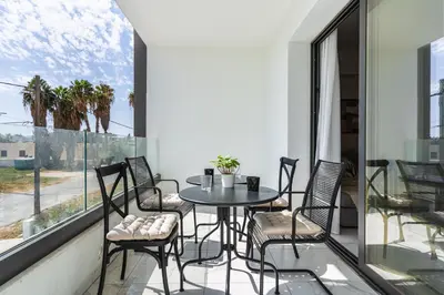 a balcony with a table and chairs and a window at Vervana 2-Bedroom Apartment in Larnaka
