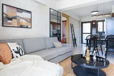 a living room with a couch and a table at Vervana 2-Bedroom Apartment in Larnaka