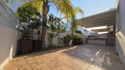an empty courtyard with a palm tree in a house at Chrystallia Protaras in Paralimni