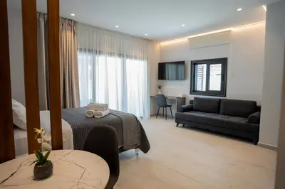 a living room with a bed and a couch at Raise Cityscape Limassol Suites in Limassol
