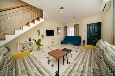 a living room with two couches and a table at 2 bedroom house near the beach in Limassol