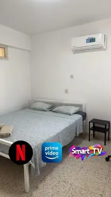 a bedroom with a bed and two stickers on the floor at Larnaca Ancient View Rooms With Smart TV & Netflix in Larnaka