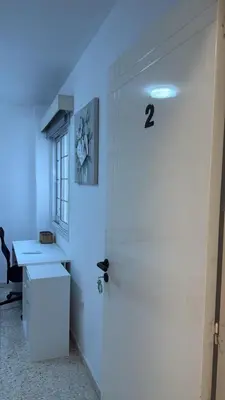 a white door in a room with a blue light at Larnaca Ancient View Rooms With Smart TV & Netflix in Larnaka