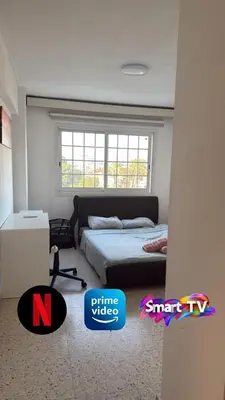 a bedroom with a bed and a window at Larnaca Ancient View Rooms With Smart TV & Netflix in Larnaka
