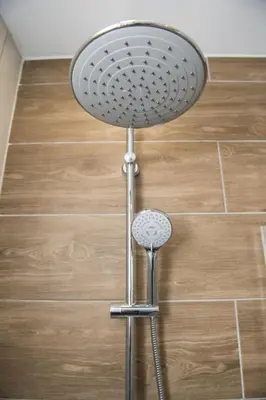 a shower head in the corner of a bathroom at STAY Glam Skin Studio in Nicosia
