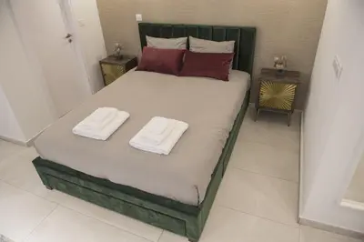 a bedroom with a bed with two towels on it at STAY Glam Skin Studio in Nicosia