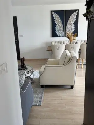 a living room with a white couch and chairs at Elegant Escape in Nicosia in Nicosia