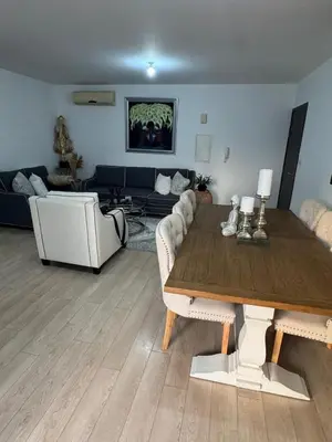 a living room with a table and a couch at Elegant Escape in Nicosia in Nicosia