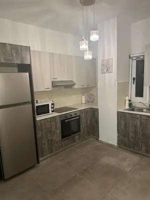 a kitchen with a refrigerator and a stove at Near Finikoudes Beach 15 in Larnaka
