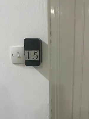 a clock on the side of a white door at Near Finikoudes Beach 15 in Larnaka
