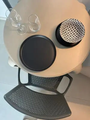 a table with wine glasses and a microphone on it at Nesseus Lux Suites - Near Unic & EUC in Ayios Dhometios