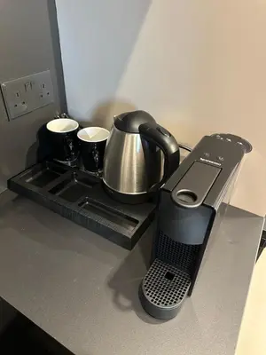 a coffee maker and a phone on a kitchen counter at Nesseus Lux Suites - Near Unic & EUC in Ayios Dhometios