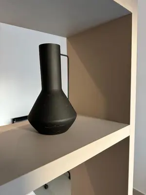 a black vase sitting on top of a shelf at Nesseus Lux Suites - Near Unic & EUC in Ayios Dhometios