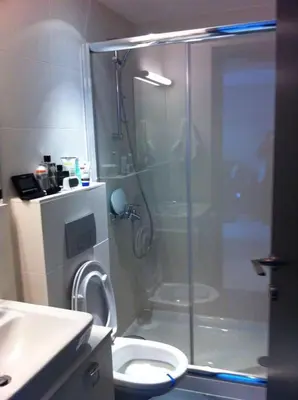 a bathroom with a shower with a toilet and a sink at Neoptolemou Residences in Nicosia