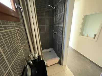 a shower with a glass door in a bathroom at Olistay in Voroklini