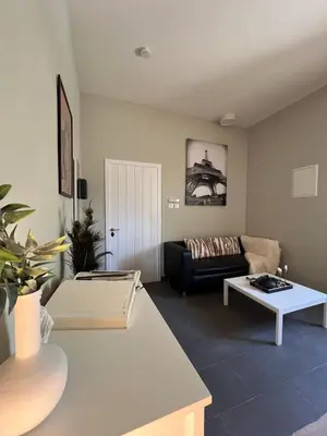 a living room with a couch and a table at Olistay in Voroklini