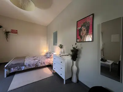 a bedroom with a bed and a dresser and a picture at Olistay in Voroklini