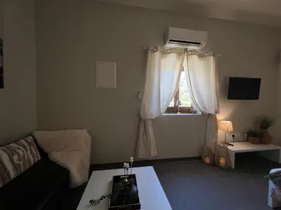 a living room with a couch and a window at Olistay in Voroklini