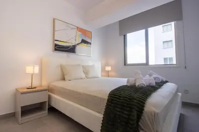 a bedroom with a bed with two teddy bears on it at Modern City Retreat - Balcony and Chic Design in Nicosia