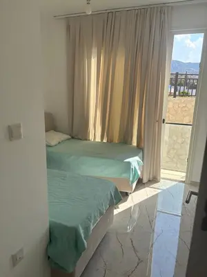 two beds sitting in a room with a window at Poseidon North Ciprus, Tatlisu