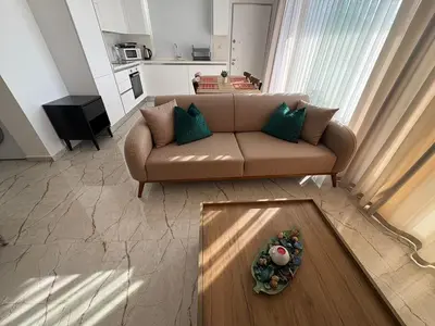 a living room with a couch and a table at Poseidon North Ciprus, Tatlisu
