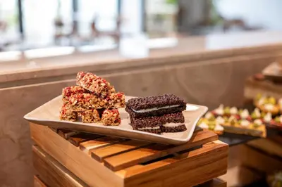 a plate with three pieces of cake on a table at Warner Boutique Hotel-Adults Only in Larnaka
