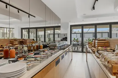 a buffet line with plates and other food at Warner Boutique Hotel-Adults Only in Larnaka