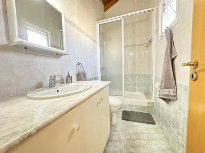a bathroom with a sink and a toilet and a shower at Serenity in the Sun - Holiday Apt - Larnaca in Larnaka