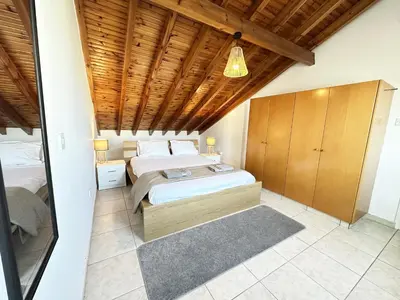 a bedroom with a bed and a wooden ceiling at Serenity in the Sun - Holiday Apt - Larnaca in Larnaka