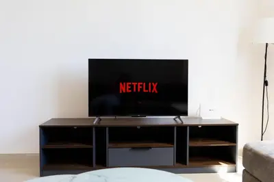 a television on a tv stand in a living room at Spacious & Bright Apartment with Balcony in Larnaka