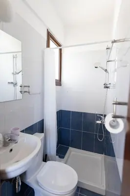 a bathroom with a sink and a toilet and a shower at Spacious & Bright Apartment with Balcony in Larnaka
