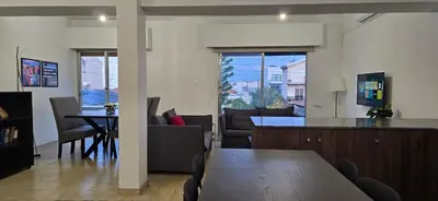 a living room with a table and a dining room at Skoufa 21 - Luxury Apartment -Breakbooking CY in Limassol