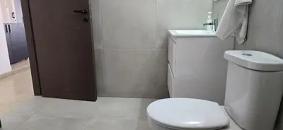 a bathroom with a white toilet and a sink at Skoufa 21 - Luxury Apartment -Breakbooking CY in Limassol