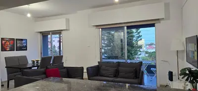 a living room with a table and chairs at Skoufa 21 - Luxury Apartment -Breakbooking CY in Limassol