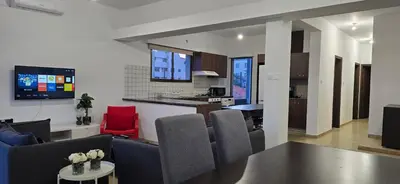 a kitchen and living room with a table and chairs at Skoufa 21 - Luxury Apartment -Breakbooking CY in Limassol